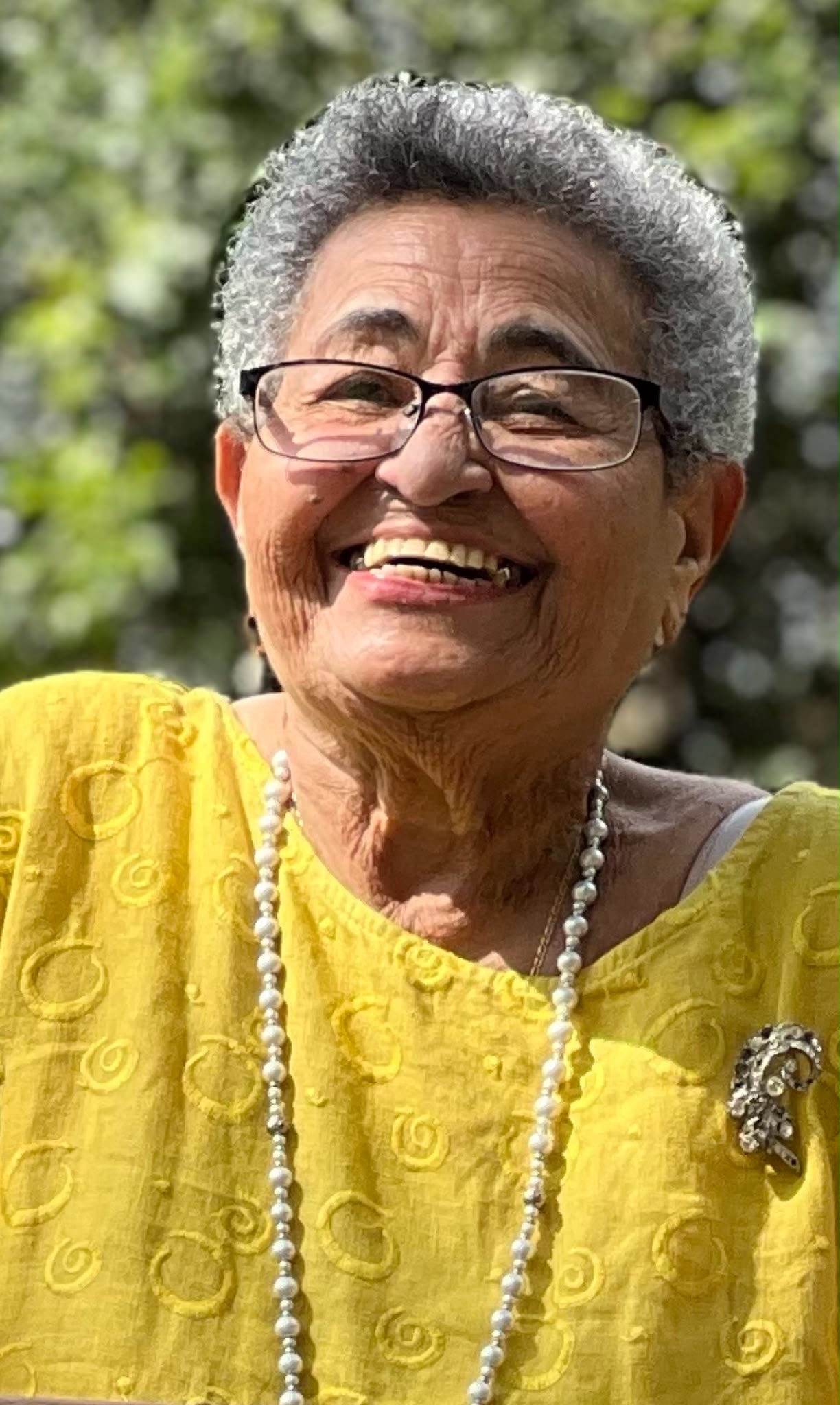 A joyful older adult laughing outdoors, representing who The CHA Foundation exists to serve
